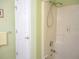 Shower featuring tile surround, grab bar, and recessed shelf at 11628 Sw 140Th Loop, Dunnellon, FL 34432