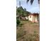 Property features a spacious yard with a shed and surrounded by mature palm trees at 12 Brook Pl, Ocala, FL 34472