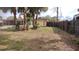 Fenced backyard featuring a lawn, mature trees, and home's exterior with screened in porch at 12 Brook Pl, Ocala, FL 34472