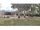 Outdoor living with a backyard pool and mature palm trees offer a relaxing setting at 12 Brook Pl, Ocala, FL 34472