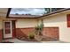 Inviting front entrance with red brick planter and matching door, offering a warm welcome at 12 Brook Pl, Ocala, FL 34472