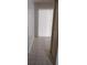 Bright hallway with tile flooring and a sliding glass door at the end at 12 Brook Pl, Ocala, FL 34472