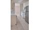 Bright kitchen with stainless steel refrigerator and white appliances with tile floors at 12 Brook Pl, Ocala, FL 34472