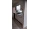 Kitchen featuring white cabinets, double basin sink, and tile backsplash at 12 Brook Pl, Ocala, FL 34472