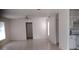 Open concept living room and kitchen featuring tile floors, ceiling fan, and natural light at 12 Brook Pl, Ocala, FL 34472