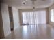 Bright living room featuring tile flooring, ceiling fan, and a sliding glass door at 12 Brook Pl, Ocala, FL 34472