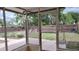Enclosed patio showing a yard with a pool and a wooden fence at 12 Brook Pl, Ocala, FL 34472