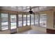 Enclosed patio with ceiling fan overlooks a swimming pool and backyard at 12 Brook Pl, Ocala, FL 34472