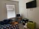 Bedroom featuring bed, window, TV, and assorted furnishings at 12 Hickory Course Way, Ocala, FL 34472