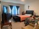 Comfortable bedroom with coordinated furniture, including two beds and a dresser with mirror at 12 Hickory Course Way, Ocala, FL 34472