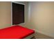 Minimalist bedroom with red mattress and window at 12 Hickory Course Way, Ocala, FL 34472