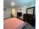 Bedroom featuring neutral walls, large mirror, and comfortable furniture at 12 Hickory Course Way, Ocala, FL 34472