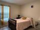 Cozy bedroom featuring a bed, mirrored dresser, and natural light at 12 Hickory Course Way, Ocala, FL 34472