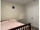 Bedroom with patterned bedding, modern nightstand, and closet with double doors at 12 Hickory Course Way, Ocala, FL 34472