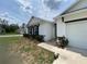 Charming single-story home with white stucco, dark shutters, and attached garage at 12 Hickory Course Way, Ocala, FL 34472
