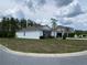 Corner lot featuring a single-story home, a well-kept lawn, and a convenient two-car garage, providing comfort and curb appeal at 12 Hickory Course Way, Ocala, FL 34472