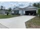 Inviting single-story home with a well-manicured lawn and a two-car garage, offering both visual appeal and practical parking at 12 Hickory Course Way, Ocala, FL 34472