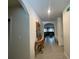 Inviting hallway featuring tile flooring, neutral walls, and decorative accents leading to a bright and airy living space at 12 Hickory Course Way, Ocala, FL 34472