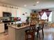 Bright kitchen with a granite island, stainless appliances, and adjacent dining area, creating an ideal space for culinary enjoyment at 12 Hickory Course Way, Ocala, FL 34472