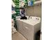 Functional laundry room with washer, dryer, and storage shelving at 12 Hickory Course Way, Ocala, FL 34472