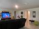 Comfortable living room featuring tile flooring, media center, and relaxed seating, creating a perfect space for relaxation at 12 Hickory Course Way, Ocala, FL 34472
