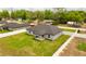 An aerial view showcases the home's layout, fenced yard, landscaping, and neighborhood at 12180 Se 89Th Ter, Belleview, FL 34420
