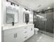 Modern bathroom features a double vanity, sleek fixtures, and a glass-enclosed shower at 12180 Se 89Th Ter, Belleview, FL 34420