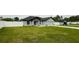 Well maintained front lawn with a charming single-story home with neutral paint and a two-car garage at 12180 Se 89Th Ter, Belleview, FL 34420