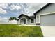 Inviting single-story home with a well-maintained lawn and covered front entry way at 12180 Se 89Th Ter, Belleview, FL 34420