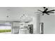 Spacious, modern kitchen with stainless steel appliances, white cabinets, and an island at 12180 Se 89Th Ter, Belleview, FL 34420