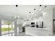 Stylish kitchen with modern lighting, stainless appliances, white cabinetry and a breakfast bar at 12180 Se 89Th Ter, Belleview, FL 34420