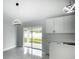 Modern kitchen featuring white cabinets, stainless steel appliances and a spacious kitchen island at 12180 Se 89Th Ter, Belleview, FL 34420