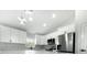 Bright, modern kitchen with stainless steel appliances, quartz countertops, and ample cabinet space at 12180 Se 89Th Ter, Belleview, FL 34420