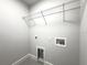 This laundry room features gray walls, a wire shelf, and hookups for your washer and dryer at 12180 Se 89Th Ter, Belleview, FL 34420