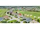 Aerial view of the home surrounded by a lush golf course community and mature trees at 12255 Se 177Th Loop, Summerfield, FL 34491