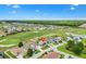 Aerial view showcasing the community featuring a golf course and numerous homes at 12255 Se 177Th Loop, Summerfield, FL 34491