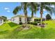 Well maintained backyard featuring lush landscaping, palm trees, and a screened-in lanai at 12255 Se 177Th Loop, Summerfield, FL 34491