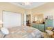 A well-lit bedroom with a double closet and a vanity offers ample storage and classic decor at 12255 Se 177Th Loop, Summerfield, FL 34491