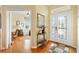 Elegant foyer featuring hardwood floors, decorative glass front door, and a view of the home office at 12255 Se 177Th Loop, Summerfield, FL 34491