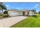 Charming single-story home with a well-manicured lawn and a two-car garage at 12255 Se 177Th Loop, Summerfield, FL 34491