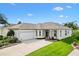 Charming single-story home with a well-manicured lawn and a two-car garage at 12255 Se 177Th Loop, Summerfield, FL 34491