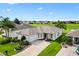Inviting single-story home boasts lush landscaping, well-kept lawn, and beautiful golf course views at 12255 Se 177Th Loop, Summerfield, FL 34491