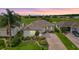 Charming single-story home with manicured landscaping and a view of the golf course at sunset at 12255 Se 177Th Loop, Summerfield, FL 34491