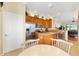 Kitchen view featuring stainless steel appliances, granite counters, breakfast nook and wood cabinets at 12255 Se 177Th Loop, Summerfield, FL 34491