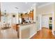 Eat-in kitchen with tile floors, an island, wood cabinets, and stainless steel appliances at 12255 Se 177Th Loop, Summerfield, FL 34491