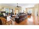 Bright open-concept living room with wood floors, sliding glass doors, and dining area at 12255 Se 177Th Loop, Summerfield, FL 34491