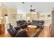 Open-concept living room showing hardwood floors, neutral walls, and view into dining area at 12255 Se 177Th Loop, Summerfield, FL 34491