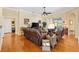 Comfortable living room with sliding glass doors to the lanai, crown molding, and hardwood floors at 12255 Se 177Th Loop, Summerfield, FL 34491
