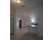 Open-concept kitchen with modern lighting, white cabinets, and a breakfast bar at 15 Juniper Trail Crse, Ocala, FL 34480