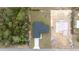 Overhead shot of a home with a dark roof, contrasted against the grass and a foundation for another structure at 16890 Sw 39Th Cir, Ocala, FL 34473